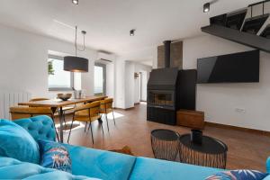 a living room with a blue couch and a table at CASA GIUSEPPE Luxury house with an amazing view in Labin