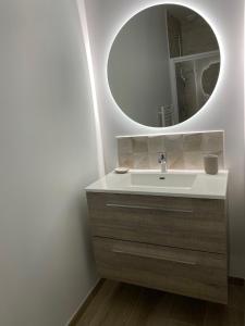 łazienka z umywalką i lustrem w obiekcie DOMUS AUREA Maison Dorée w mieście Jard-sur-Mer