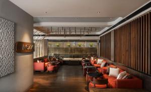 a lobby with orange chairs and a waiting room at The Avenue Regent in Cochin