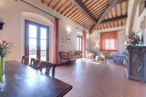 a large living room with a table and chairs at Fattoria di Macia in Calenzano