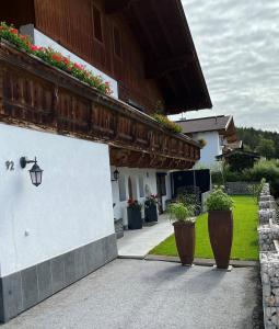 a building with potted plants on the side of it at Ferienwohnung Schmiedhofer in Ellmau