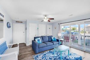 a living room with a couch and a table at St. Martin Beachwalk Villas 111 in Destin