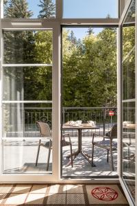 a screened in porch with a table and chairs at Aries Hotel & SPA Wisła in Wisła