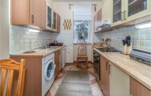 a kitchen with a washer and dryer in it at 3 Bedroom Nice Home In Crikvenica in Crikvenica