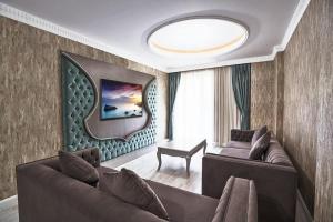 een woonkamer met twee banken en een tafel bij Sarot Thermal Palace Tatil Köyü - Halal Hotel in Karacasumandıra