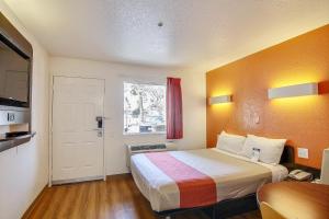 a hotel room with a bed and a window at Motel 6-Ventura, CA - South in Ventura