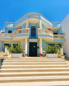 a house with stairs in front of it at B&B La Perla in Racale