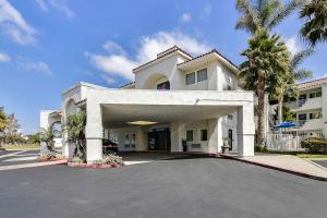 a large white house with a parking lot at Motel 6-Ventura, CA - South in Ventura