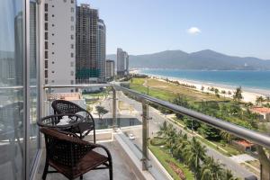a balcony with two chairs and a view of the beach at Sekong Hotel Da Nang in Da Nang