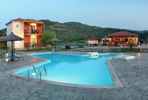 a large swimming pool in front of a house at YAKINTHOS GARDEN in Mytilene