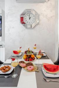 uma mesa com pratos de comida e um relógio na parede em Villa Anita, Cavtat em Cavtat