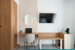 a room with a desk with a laptop and a mirror at Nerja VG Hostal Boutique in Nerja