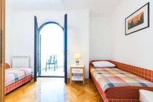 Postel nebo postele na pokoji v ubytování Apartments Villa Mirella