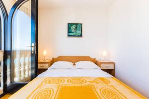 Postel nebo postele na pokoji v ubytování Apartments Villa Mirella