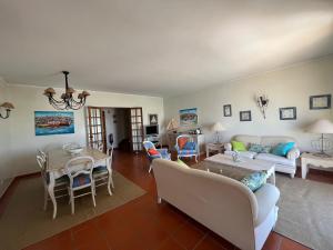 a living room with a couch and a table at Marina de Vilamoura Apart in Vilamoura