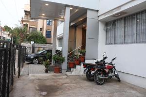 a motorcycle parked in front of a house at Hotel New Samrat in Aurangabad