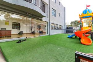 a yard with a playground in a building at Kileleshwa Lavington Shii apartment in Nairobi