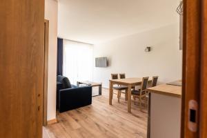 a kitchen and dining room with a table and chairs at Apartamenty Henry in Łeba