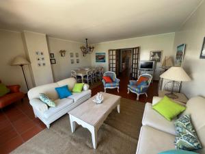 a living room with two couches and a table at Marina de Vilamoura Apart in Vilamoura