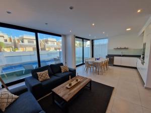 a living room with a couch and a table at Lo Pagan Holiday House in San Pedro del Pinatar