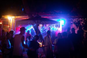 a crowd of people in a bar at night at Sabaii Bay Resort in Ban Tai +116 photos