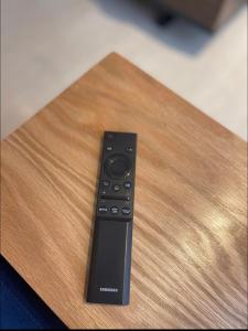 a remote control sitting on top of a wooden table at Cosy appartement à Ain Diab beach in Casablanca