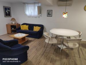 a living room with a blue couch and a table at Garden apartment Vanya in Split +26 photos