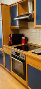 a kitchen with a stove top oven in a kitchen at Jade FeWo Cottbus in Cottbus +5 photos