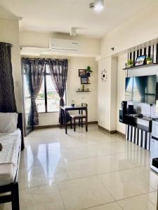 a large living room with a table and a couch at Mabolo Garden Flats Cebu in Cebu City