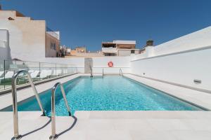 a swimming pool in the middle of a building at Nerja VG Hostal Boutique in Nerja