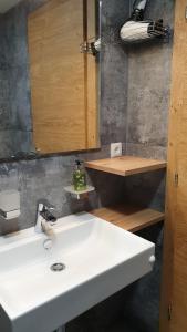 a bathroom with a white sink and a mirror at Gästeheim Lederle in Jerzens