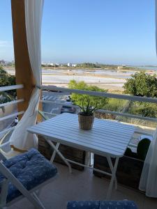 a blue table on a balcony with a plant at La Savina Ses Platgetes in La Savina