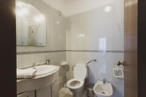 a bathroom with a sink and a toilet and a mirror at Best Houses 20 - Lovely Apartament - Peniche in Peniche