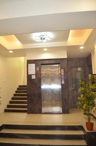 a lobby with stairs and elevators in a building at Hotel O2 Sangli in Sangli