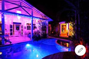 a house with a swimming pool at night at Blue Lagoon 5 bedrooms Villa in Kuta