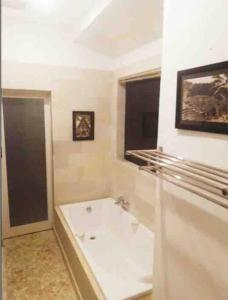 a white bathroom with a tub and a window at Blue Lagoon 5 bedrooms Villa in Kuta +39 photos