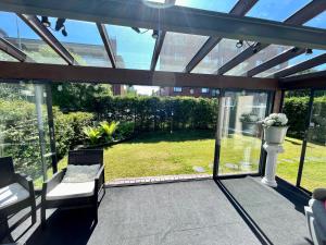 a screened in porch with a view of a yard at Design Guesthouse Laanila in Oulu