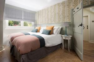 a bedroom with a large bed and a window at Campsie Cottage in Ancrum