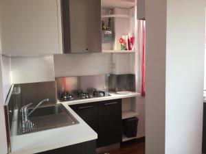 a kitchen with a sink and a stove top oven at Splendido Bilocale adiacente metro M5 - Ca Granda in Milan