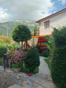 a garden with flowers and plants in front of a building at Yard House Trpejca in Ohrid