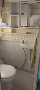 a small bathroom with a toilet and a sink at Mi Cachito in Los Caños de Meca