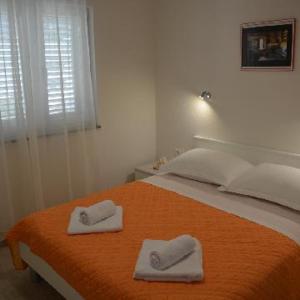 Postel nebo postele na pokoji v ubytování Apartments Leon