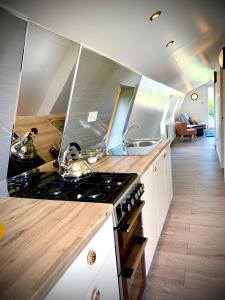 a kitchen with a stove and a sink at Glamping at Shieling Holidays Mull in Craignure