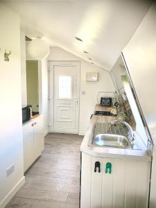 a kitchen with a sink and a counter top at Glamping at Shieling Holidays Mull in Craignure