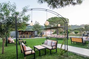 a group of benches sitting in a park at Aeolos Zante Villas with Heated Pool in Vasilikos