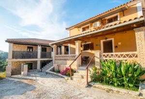 a house with a pathway in front of it at Aeolos Zante Villas with Heated Pool in Vasilikos