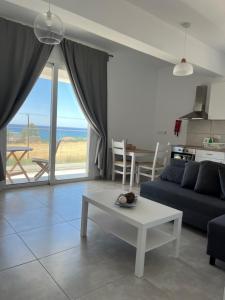 a living room with a couch and a table at Blue Seaview Appartments in Paphos