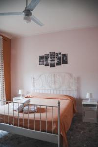 a bedroom with a white bed and two night stands at La Casa Della Nonna in Montemiletto