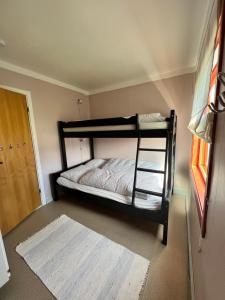 a bedroom with two bunk beds and a window at Lyngen House in Olderdalen