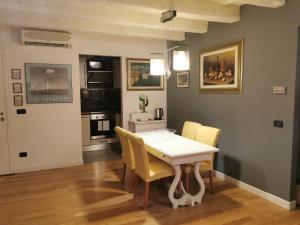 une salle à manger avec une table et des chaises jaunes dans l'établissement BORGO LA CROCE APARTAMENTS, à Florence